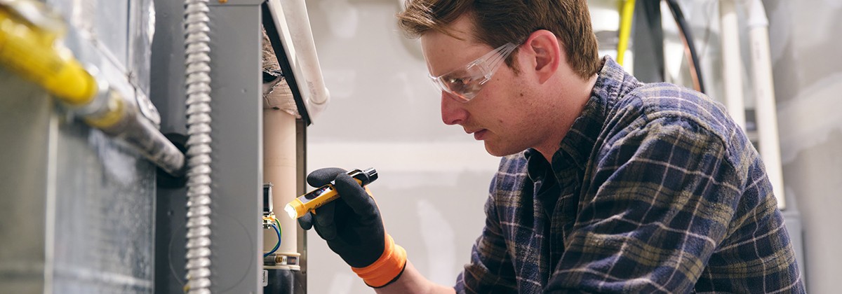 maintenance-man-fixing-furnace-wearing-protective-glasses